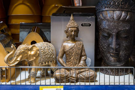 April 12, 2021 Beltsy, Moldova goods on the market shelf. Supermarket showcase. Illustrative editorial. Buddha statue for yard decorのeditorial素材