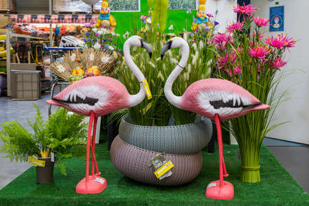 April 12, 2021 Beltsy, Moldova goods on the market shelf. Supermarket showcase. Illustrative editorial. Decorative pink flamingos and artificial flowers for the yardのeditorial素材