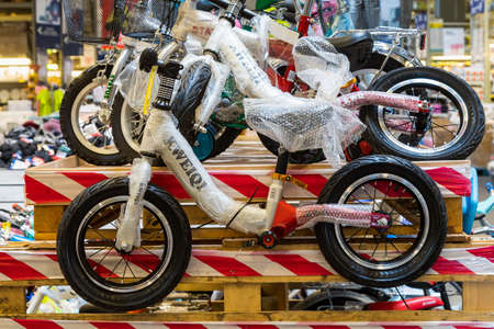 April 12, 2021 Beltsy, Moldova goods on the market shelf. Supermarket showcase. Illustrative editorial. Childrens bike transportのeditorial素材