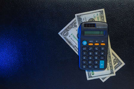 US dollars and calculator. Economic background with place for text or calculations.の写真素材