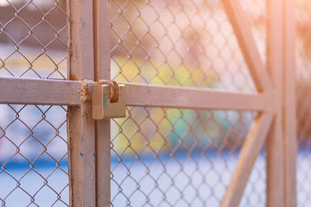 Padlock on the fence. Selective focus background with copy space