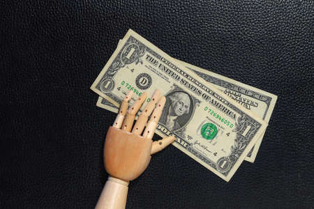 US dollars and hand. Economic background with place for text or calculations.の写真素材