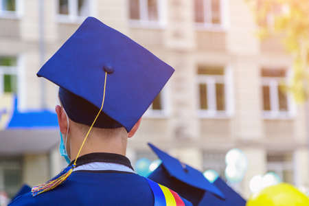 The back of a graduate wearing a square, quadrangular academic cap. Graduation day.の写真素材