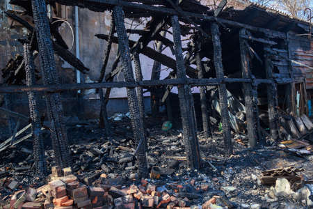 The aftermath of a fire in old wooden sheds. Background