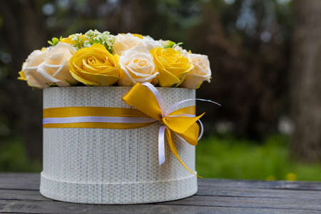 Very beautiful gift bouquet of artificial decorative roses. Background with place for text or inscriptionの写真素材