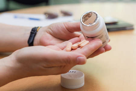 Modern medicines for HIV infection. AIDS pills in a female hand. Copy space for text. Balti, Moldova May 12, 2021. Illustrative editorial.のeditorial素材