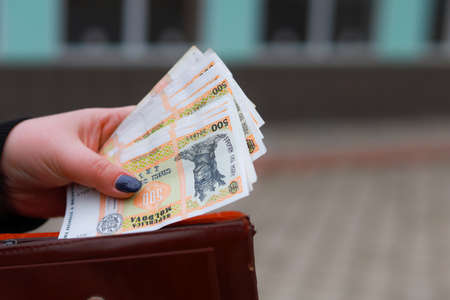 Moldovan lei MDL in female hands. Economic background with copy space for text