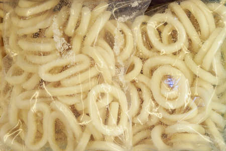 Frozen squid rings. Freezer with seafood in the fish market. Backgroundの写真素材