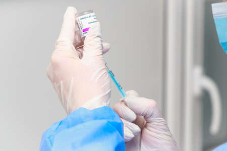 The hands of a medical staff with a syringe during a real vaccination. May 5, 2021, Balti Moldova,...