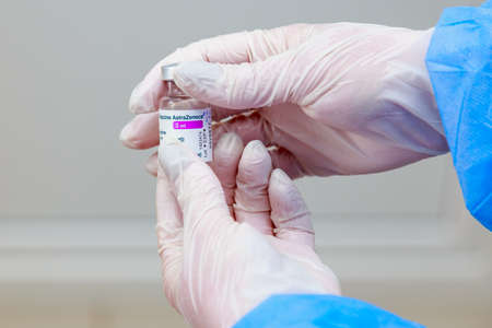 Hands of medical staff wearing gloves with vaccine against coronavirus infection covid-19. May 5, 2021, Balti Moldova, Illustrative editorial. Selective focus.のeditorial素材