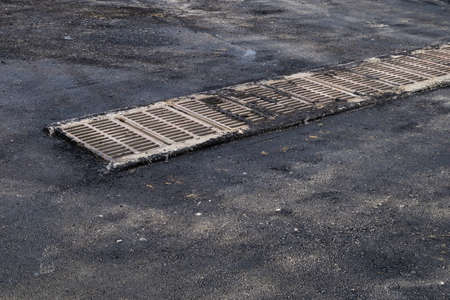 Drainage grates in an urban environment. Abstract background with copy space for text