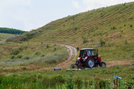 The tractor pumps water. Background with copy space for text or inscriptions. Illustrative...