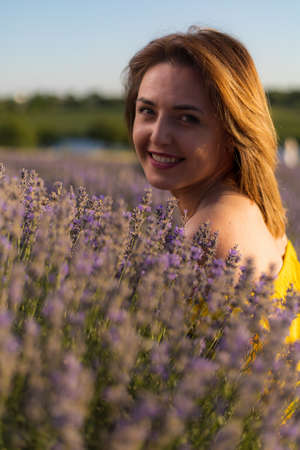 Woman portrait in lavender field. Selective focus, blurred background, tonedの写真素材