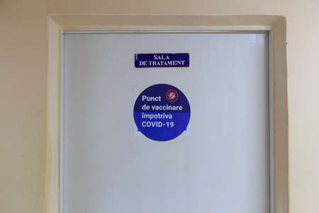 A sign on the door of the first COVID-19 vaccination center. Romanian text. March 2, 2021, Balti...