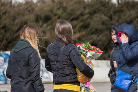 People in the market buy flowers. March 7, 2021 Balti Moldova. Illustrative editorialのeditorial素材