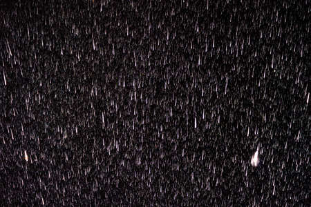 Raindrops on a black background. Rain in the dark. Graphic resource or template for editing. Blank for a retoucher.の写真素材