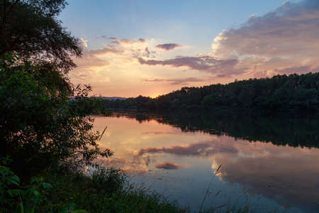 Sunset or sunrise on the river. Nature background with copy space for text or lettering.の写真素材