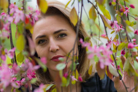 Portrait of a woman in the park during the flowering trees.の写真素材