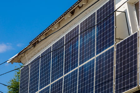 Solar panels for generating electricity in city architecture. Home farm of sustainable energy. Background with copy space for text or inscriptions.の写真素材