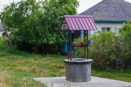 An old manual well with drinking water. Background with copy space for text or inscriptions.の写真素材