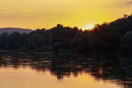 Sunset or sunrise on the river. Nature background with copy space for text or lettering.の写真素材