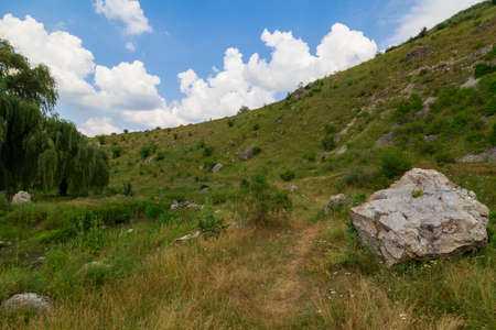 Wild hilly and rocky nature. Eastern european background with copy space for text or letteringの写真素材