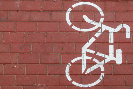 Cycle path pedestrian warning sign. Sidewalk markings. Dedicated lane for cyclists in the pedestrian zone of the urban environment. Background with copy spaceの写真素材