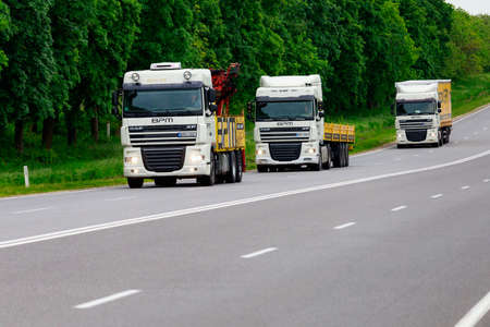 Trucks are carrying cargo. Background with copy space for text or inscriptions. Illustrative editorial. May 25, 2021 Balti Moldova.のeditorial素材