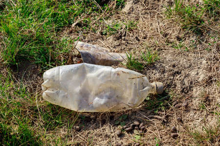 Bottles discarded in nature. Environmental pollution with plastic waste. Hazardous and toxic waste....