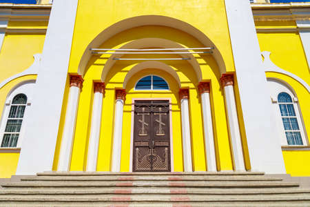 Entrance to the church. Beautiful classical old architecture. Travel and sightseeing trips. Background with copy space for text or inscriptions.の写真素材