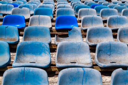 Destroyed stadium stands. Broken fan chairs. Selective focus backgroundの写真素材