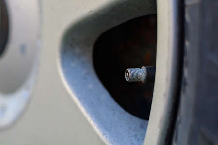 Wheel nipple without cap. Place the air replenishment tires. Toned background with selective focus and copy space for text or lettering.の写真素材