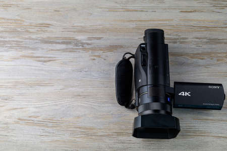 Handicam or a small handheld video camera is on the table. Tool operator or a journalist. Background with copy space for text. Illustrative editorial. September 3, 2021 Balti Moldova.のeditorial素材