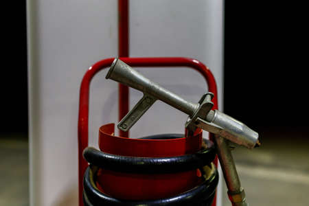 Fire extinguisher is a fire safety requirement. Gas station for transport. Background with copy space for text or inscriptions. July 25, 2021 Beltsy Moldova.のeditorial素材