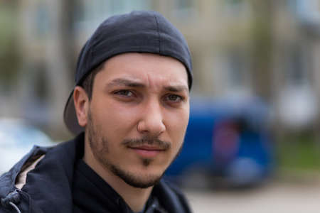 Portrait of a handsome guy on a blurred background with selective focus and copy space for text.の写真素材