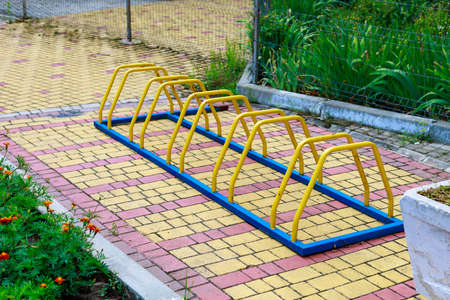 Metallic elements of urban architecture for bicycle parking near buildings in the city. Background with copy space for text or inscriptions.の写真素材