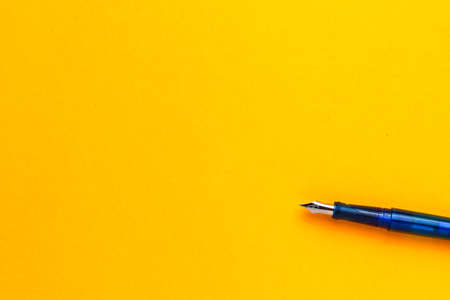 Pen on a yellow background with a copy space for text or inscriptions.の写真素材