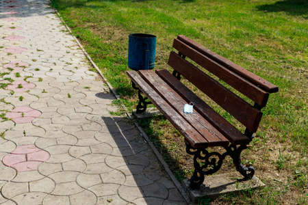 Empty bench in a city park. Background with copy space for text or lettering.の写真素材
