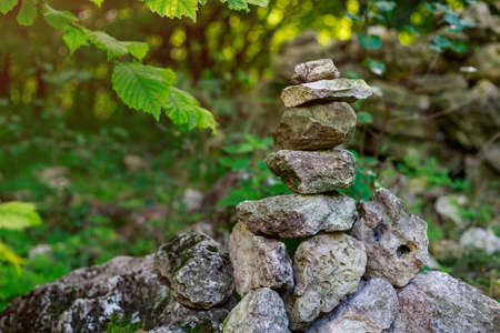 Pyramids of stones at the foot of the mountains in the forest. Symbolic places of spiritual power. Background with copy space for text or lettering. Tonedの写真素材