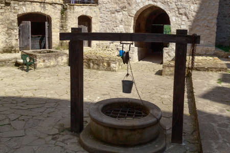 An old manual well with drinking water. Background with copy space for text or inscriptions.の写真素材