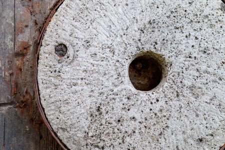 Millstones of an old retro vintage hand mill. Background with copy space for text or inscriptions.の写真素材