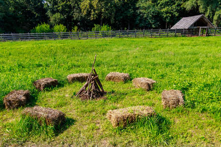 Pressed parallelepipeds or hay cubes used for seat instead of benches. Village rest after work....