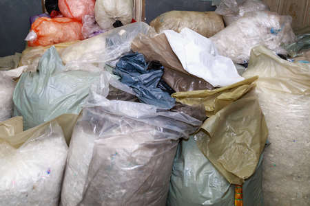 Sorted plastic and polyethylene for recycling. Factory garbage warehouse background. Environment ecology concept.の写真素材