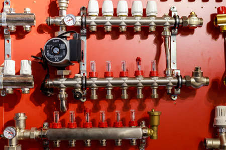 Combs from plumbing store connections and boiler room objects. Background with selective focus and copy space for text or lettering. Illustrative editorial. September 24, 2021 Balti Moldova.のeditorial素材