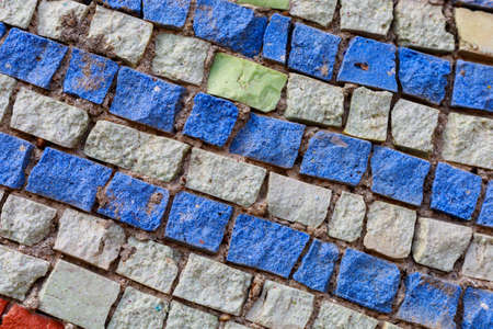 Mosaic elements in the old historical architecture of the urban environment. Rough textured...