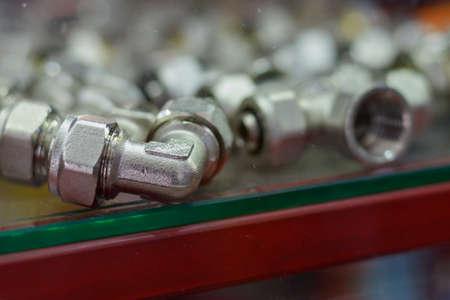 Fittings in a plumbing and boiler room objects store. Background with selective focus and copy space...