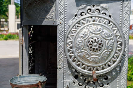 Traditional countryside old retro vintage decorative elements on a drinking well. Background with copy space for text or lettering.の写真素材