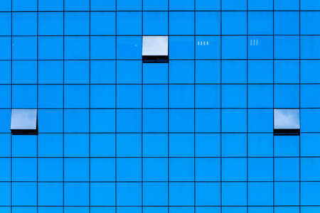 Glass facades of buildings. Element of architecture. Textured background. Blank for design. Underlay or undercoat. Copy space for textの写真素材