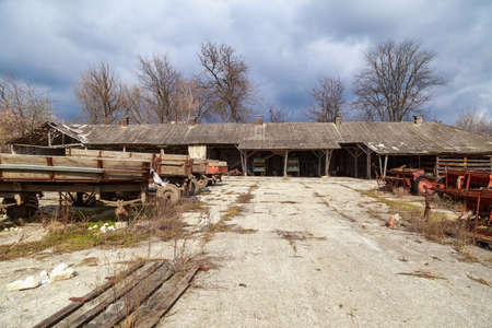 Devastation and decline in the agro-industrial sector. Cemetery of old rusty agricultural machinery. Industrial area. Backgroundの写真素材