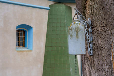 The church bell in the monastery is installed on a tree. Background with copy space for text or inscriptions.の写真素材